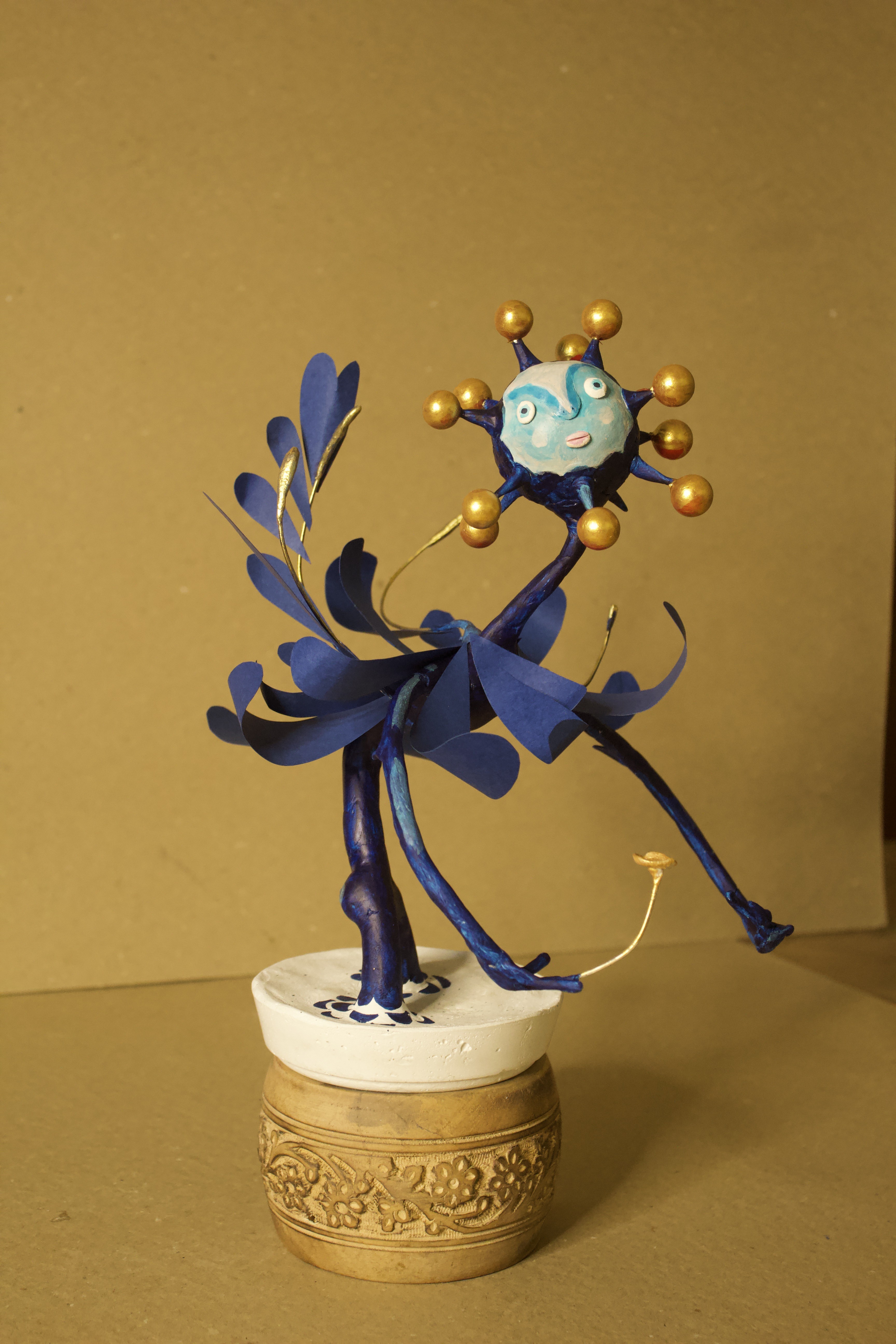Blue paper mache dancer sculpture — alternate angle on brass base
