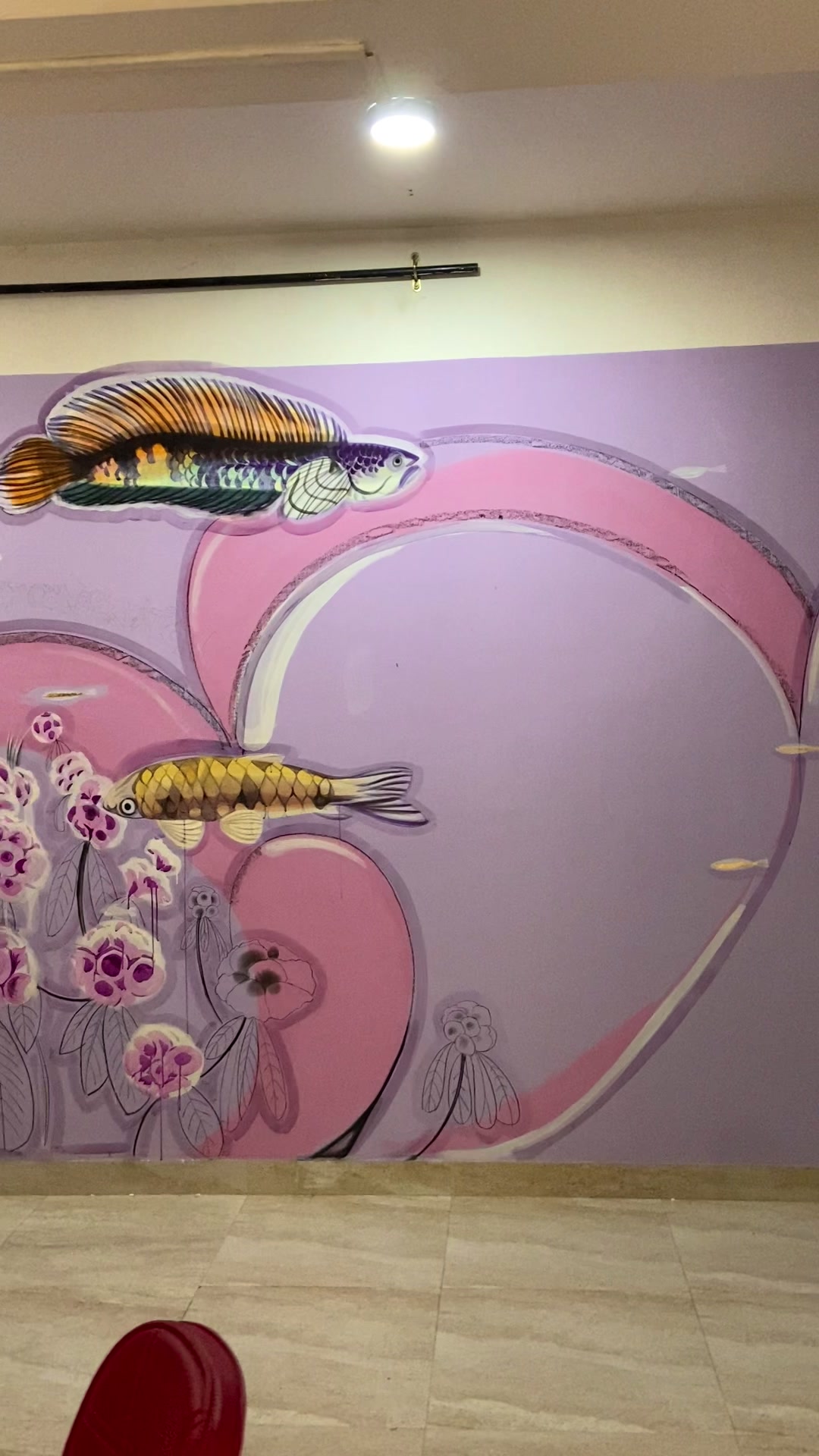 Mural detail: fish swimming through pink and purple organic forms