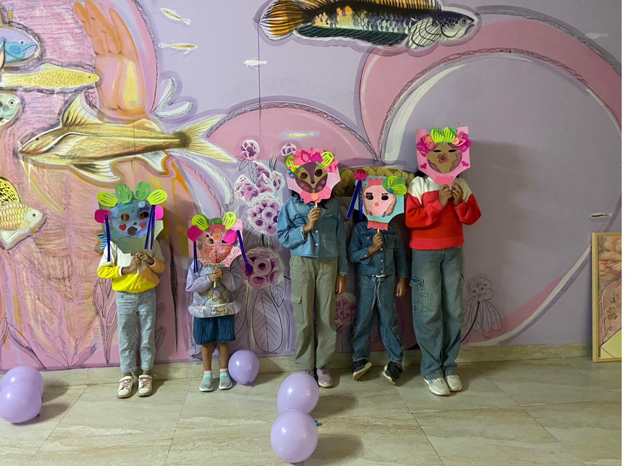 Group of children holding handmade animal masks